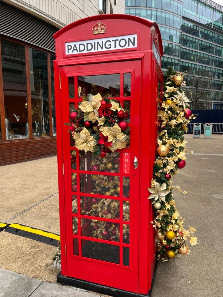 a red phone booth decorated with christmas decorations