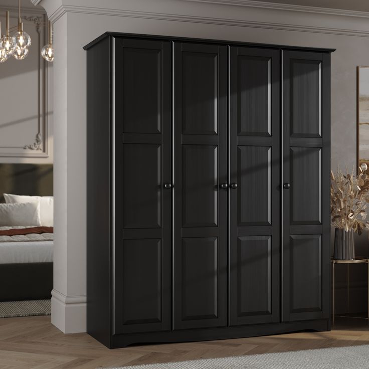 a black armoire in a room with a white rug and chandelier hanging from the ceiling