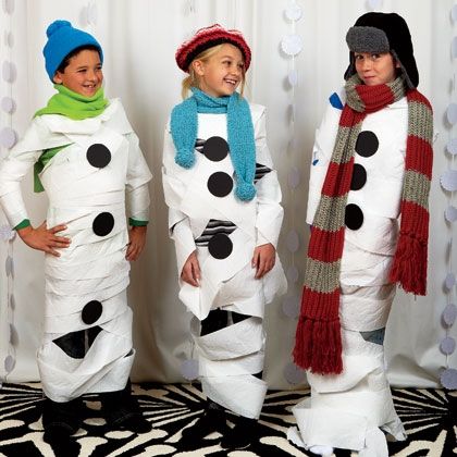 three people dressed up in snowmen costumes