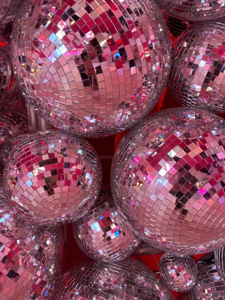 many shiny disco balls are stacked on top of each other