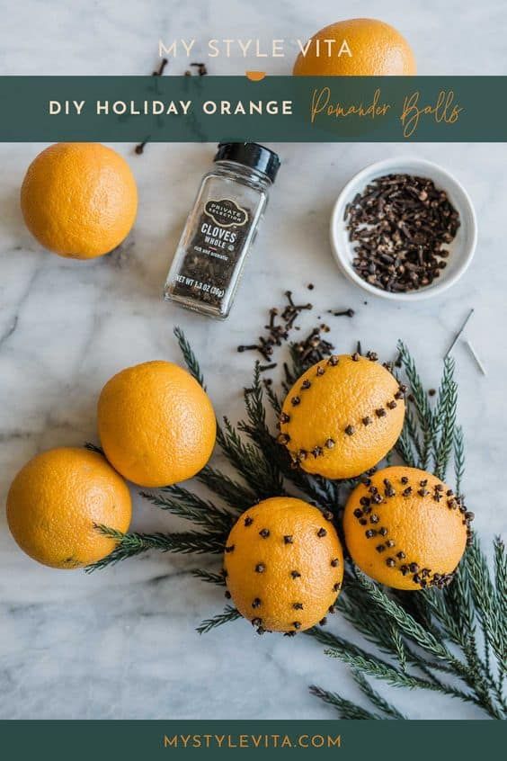 oranges and spices on a marble countertop with rosemary sprigs, salt and pepper