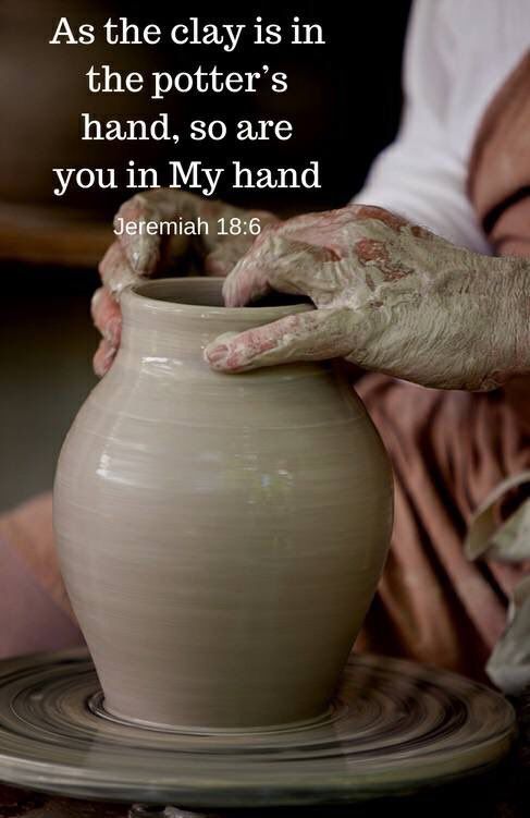 a person holding a clay pot with their hands on it