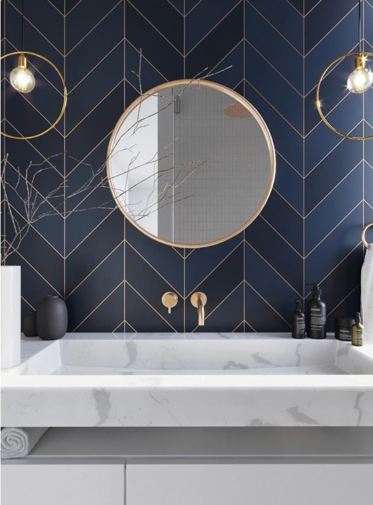 a white sink sitting under a mirror next to a wall mounted faucet in a bathroom