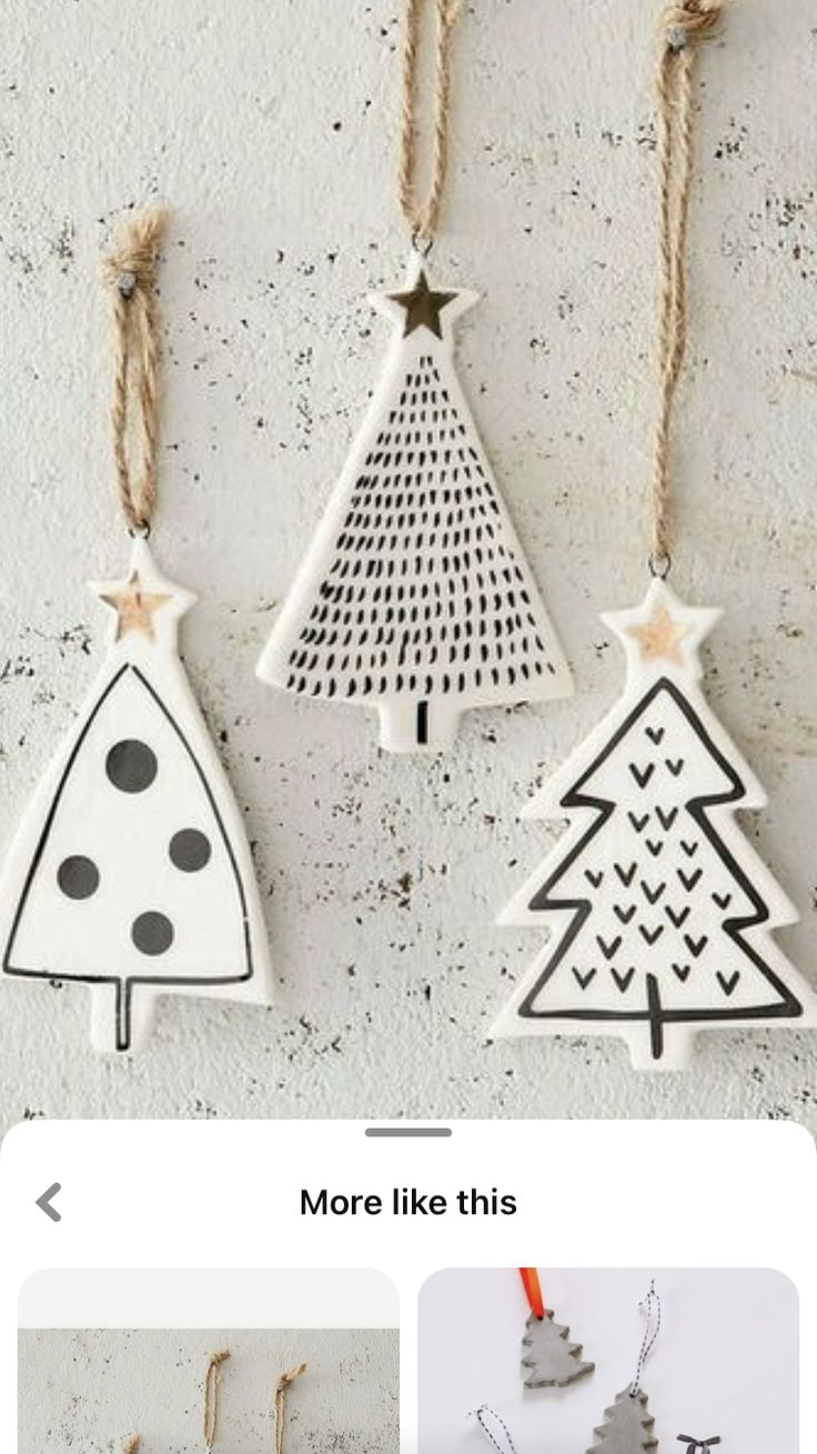 three wooden christmas trees hanging from strings on a wall with text overlay that reads, more like this