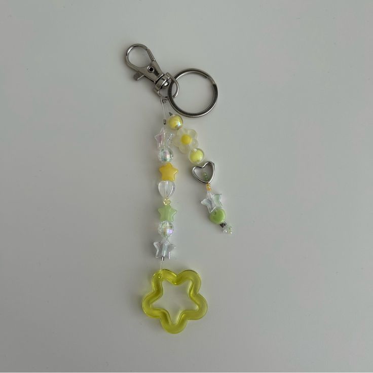 a keychain with beads and charms attached to it on a white table top