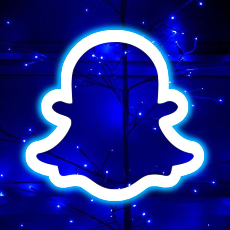 a blue snap icon is lit up in front of a dark background with white lights