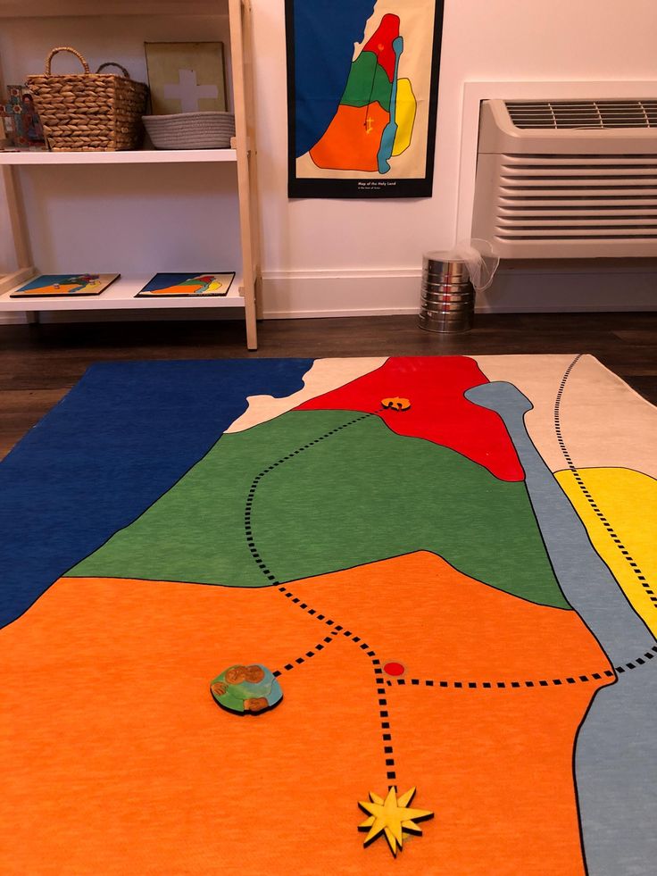 a colorful area rug is on the floor in front of a radiator and bookshelf