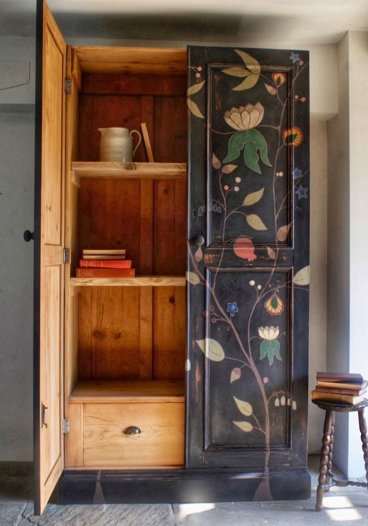 an armoire painted with flowers and leaves