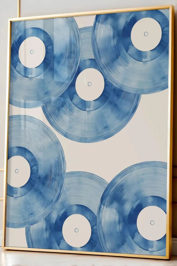 a blue and white wall hanging on the side of a wooden shelf next to a vase