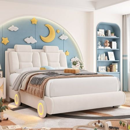 a bedroom with a white bed and blue bookcases on the wall behind it