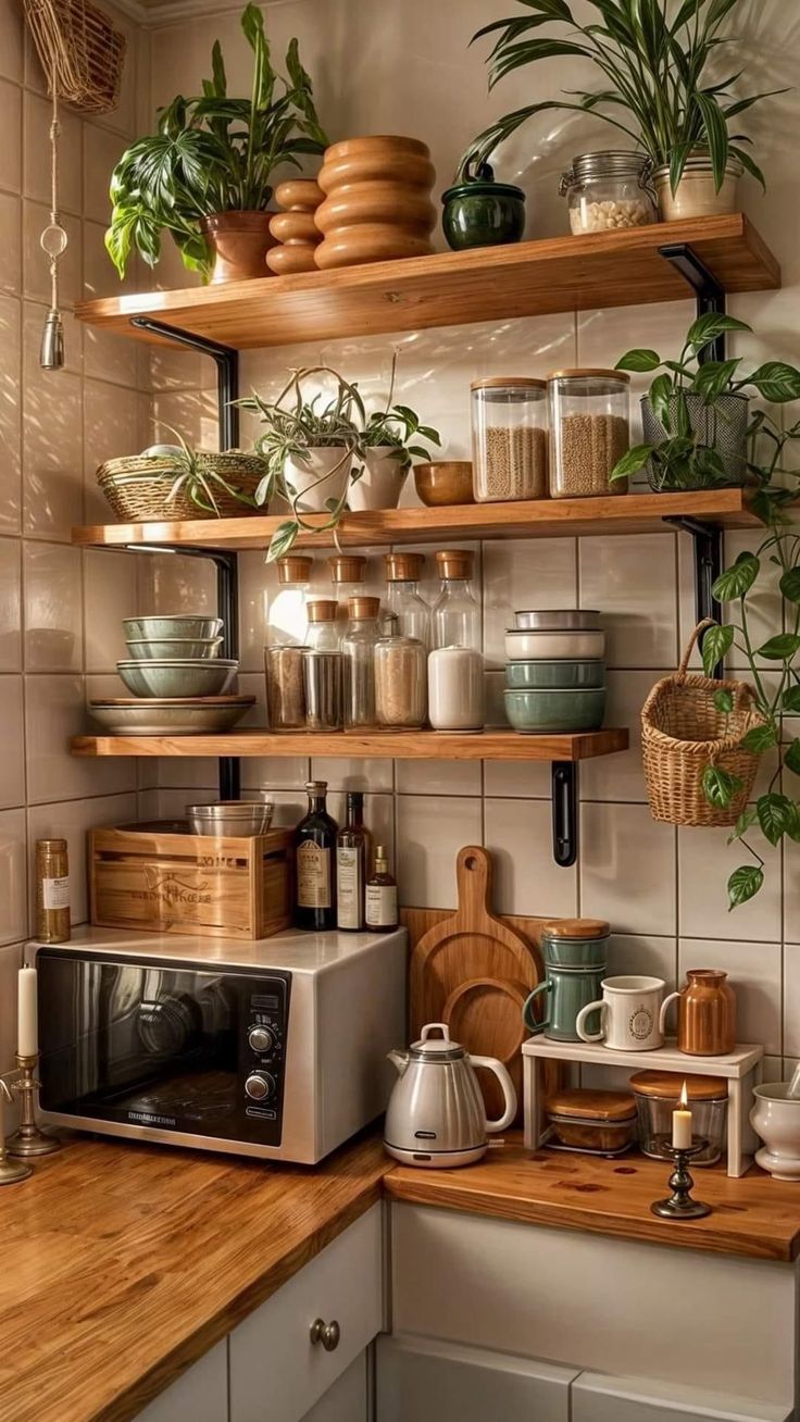 a kitchen filled with lots of pots and pans on top of wooden shelves next to a microwave