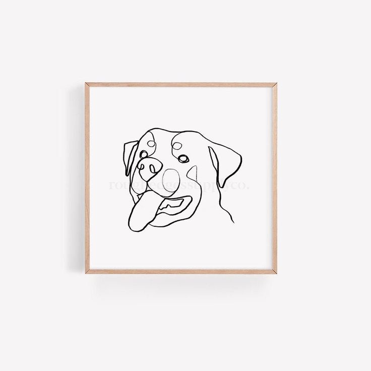 a black and white drawing of a dog's face in a wooden frame on a wall