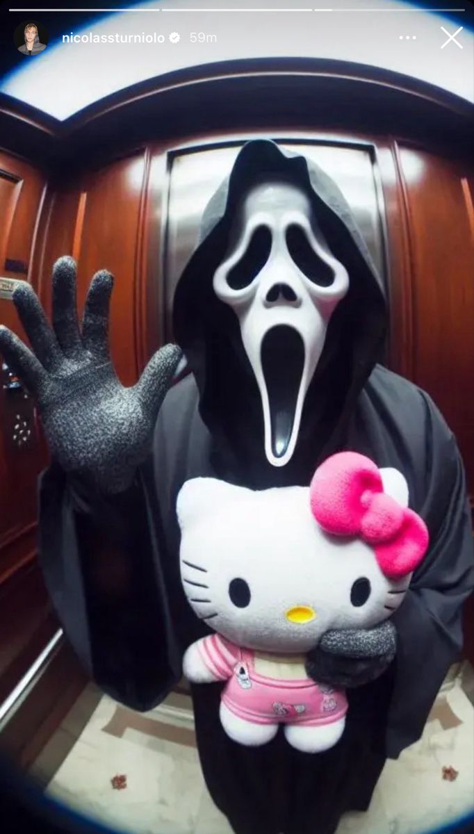 a person in a hello kitty costume holding onto a stuffed animal with its mouth open