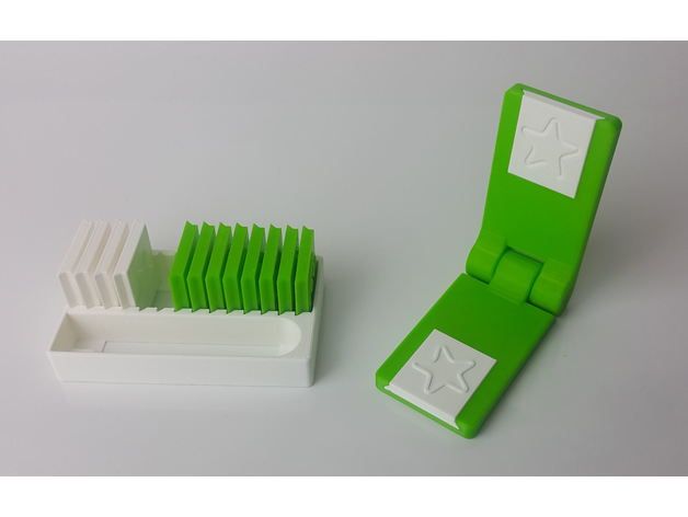 two green and white toothbrush holders sitting next to each other