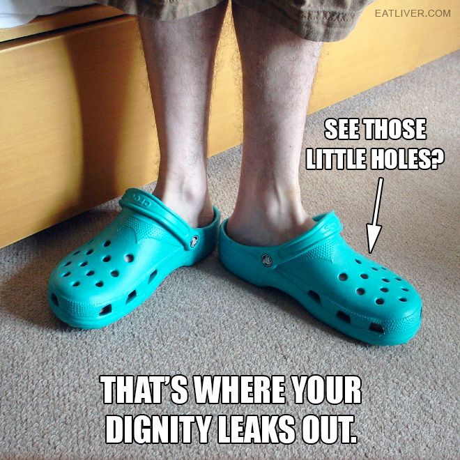 a person wearing blue crocs standing on the floor