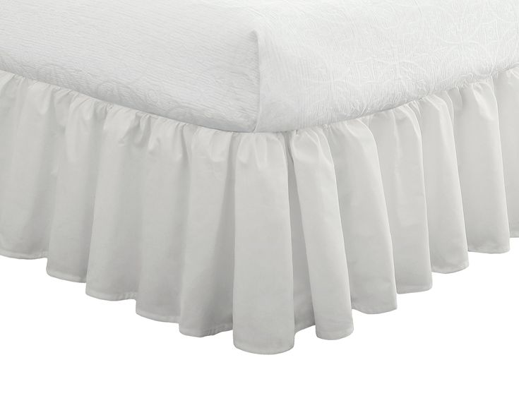 a white bed skirt with ruffled edges