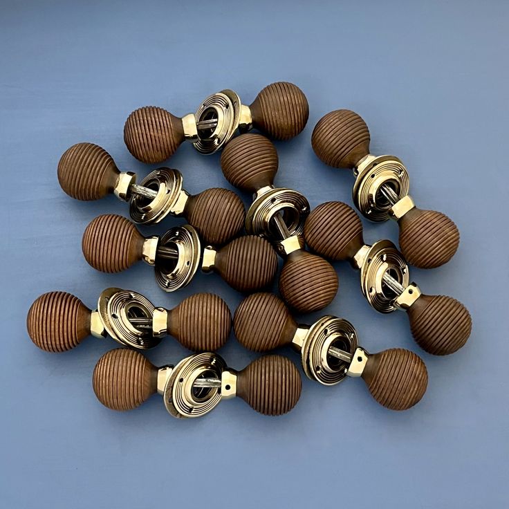 a bunch of wooden knobs on a blue surface