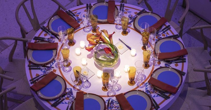 an overhead view of a dining table with place settings and candles on the centerpiece