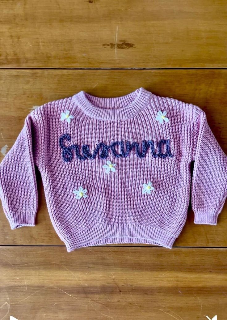 About this item Custom hand-embroidered sweaters for sizes 0-3 months - 5t. Fully customizable! You choose the sweater color, yarn color(s), personalization, and font! I love to collaborate, so please message me if you have any additions you'd like. I want you to LOVE the sweater! Each design is made-to-order, I hand embroider every single design with a needle and yarn. Right now my turn around time is 1-2 weeks.  Due to the nature of this product I cannot do returns on custom prints. However, I want you to be 100% satisfied with your purchase so I'll work directly with you to make the design perfect. So if you have any questions or concerns please be sure to ask them before or at checkout. Name Sweater Baby, Embroidered Sweaters, Name Sweater, Toddler Sweater, Knit Sweaters, Personalized Baby Shower, Embroidered Sweater, Kids Sweater, Baby Sweaters