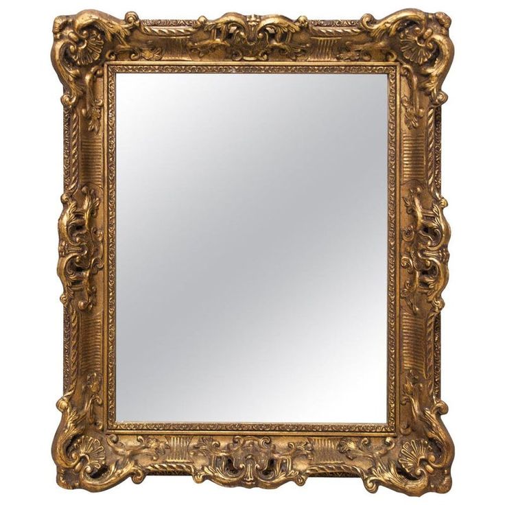 an ornate gold framed mirror against a white background