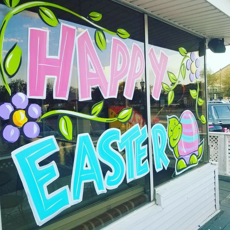 a store window with the words happy easter painted on it