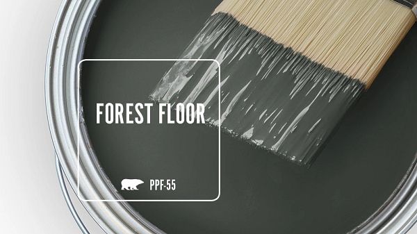 a paint can with a brush in it and the words forest floor painted on it