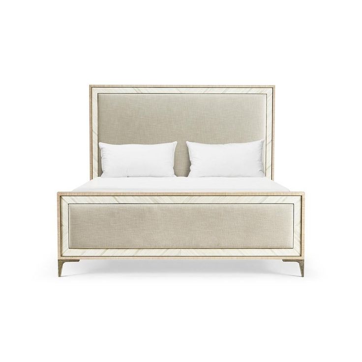 a white bed with two pillows on top of the headboard and foot board, in front of a white background