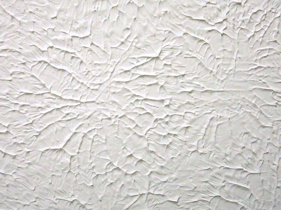 the texture of white paint on a wall is very artistic and interesting to look at