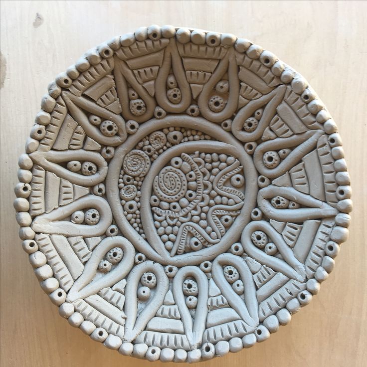 a decorative bowl sitting on top of a wooden table