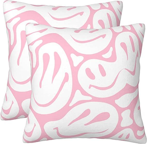 two pink and white pillows with swirl designs on them, one in the shape of a heart