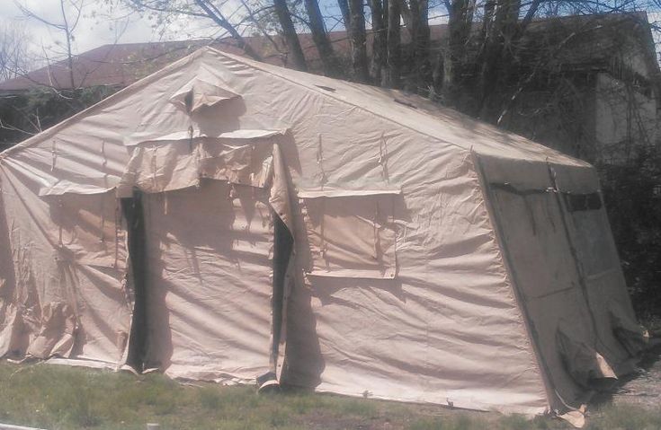 there is a tent that has been set up in the yard for people to use