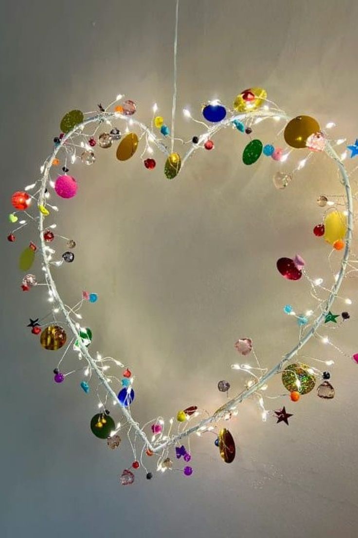 a heart shaped decoration with lights and ornaments