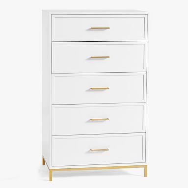 a white chest of drawers with gold handles on the top and bottom, against a white background