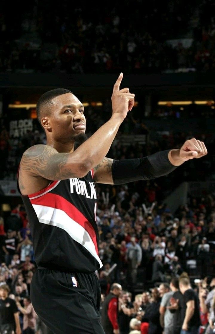 a basketball player holding his hand up in the air