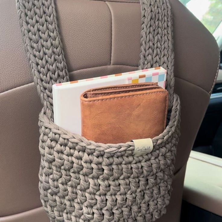 a car seat with a wallet in the back pocket