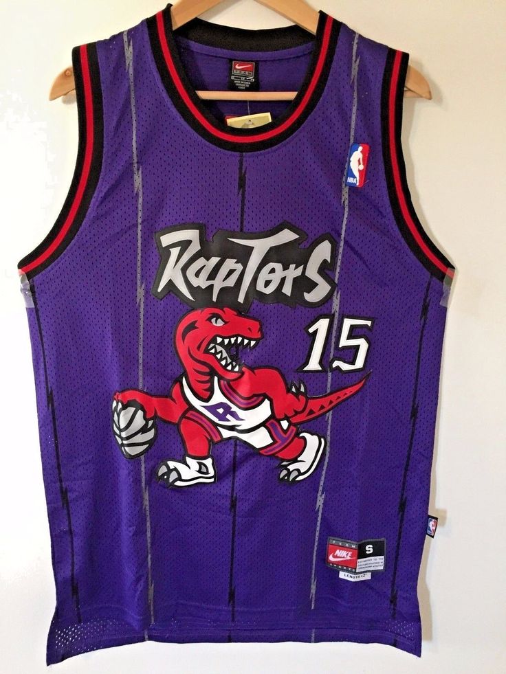 a purple raptors basketball jersey hanging on a hanger next to a white wall