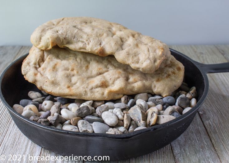 two cookies sitting in a skillet on top of rocks