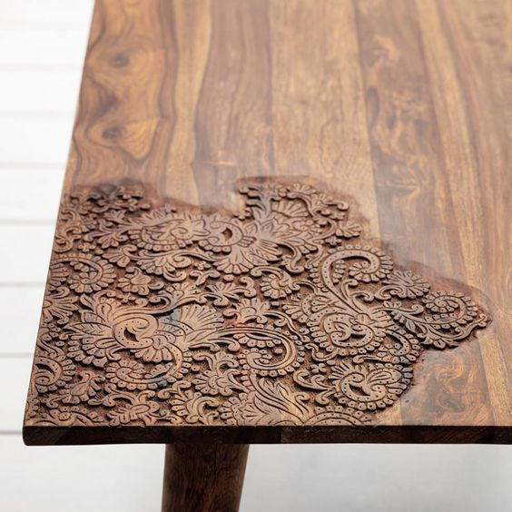 a wooden table with intricate carvings on it