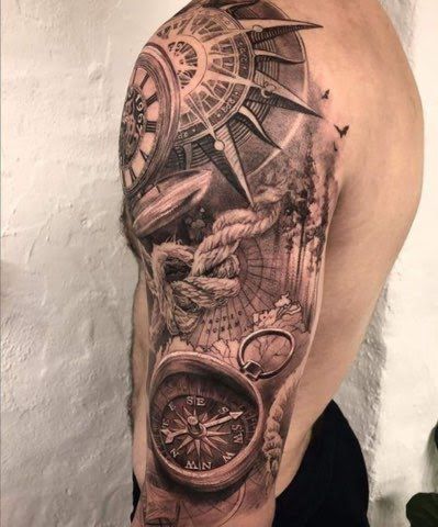 a man with a tattoo on his arm that has an image of a clock and compass