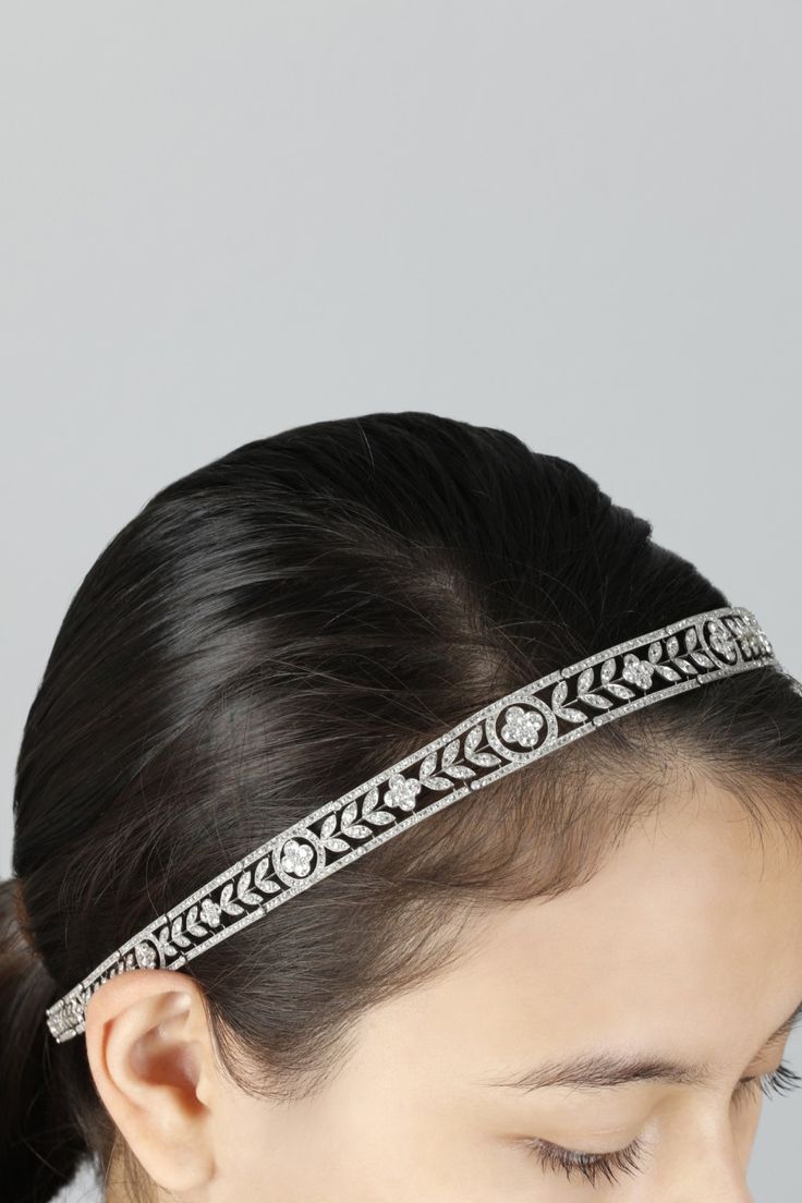 a woman wearing a headband with an intricate design