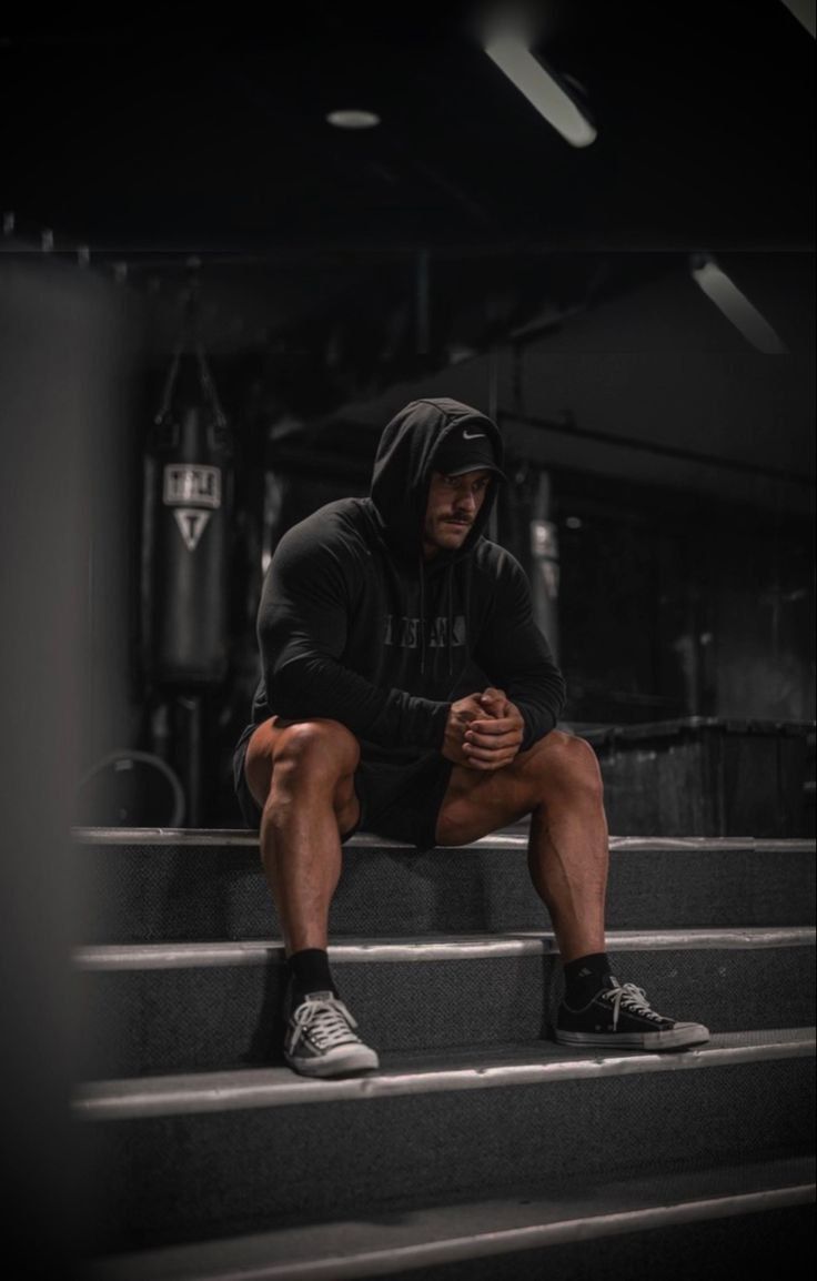 a man sitting on some stairs in the dark