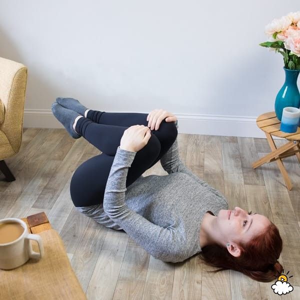 a woman laying on the floor with her legs crossed