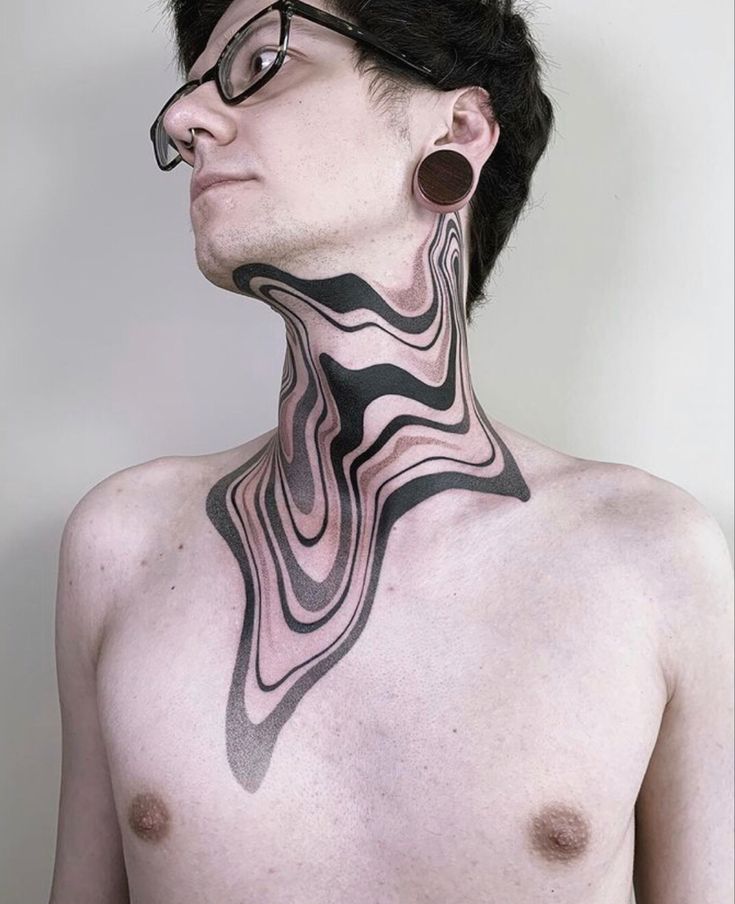 a man with black and white tattoos on his neck