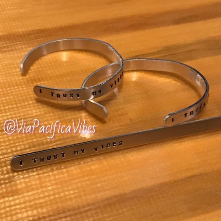 two stainless steel bracelets that say trust, trust and trust with words on them