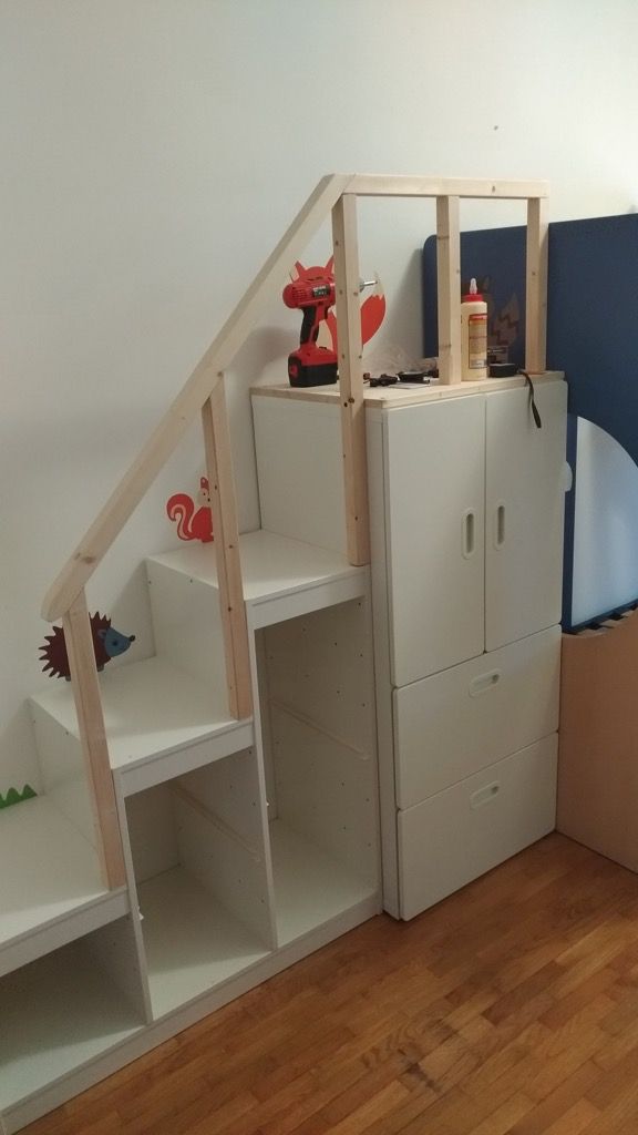 a child's room with bunk beds, bookshelves and cupboards in it