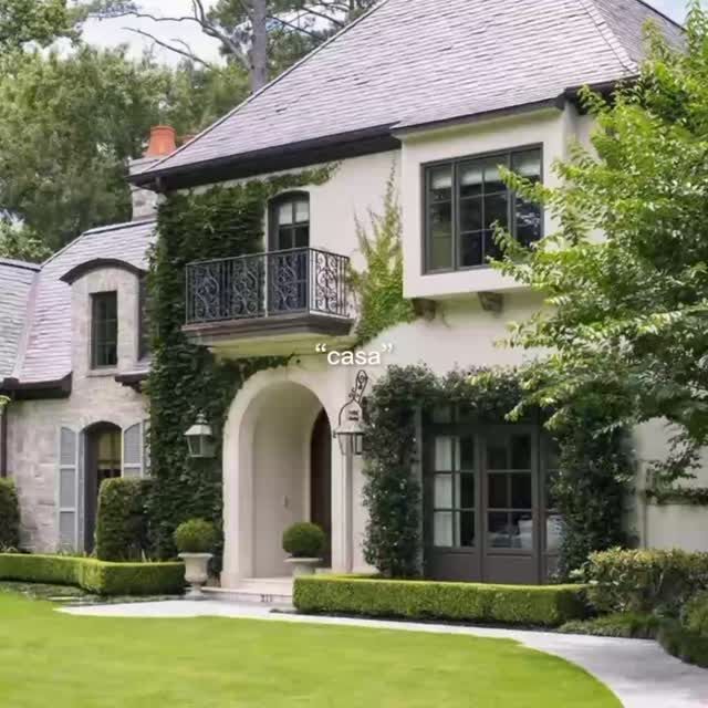 a large white house covered in ivy