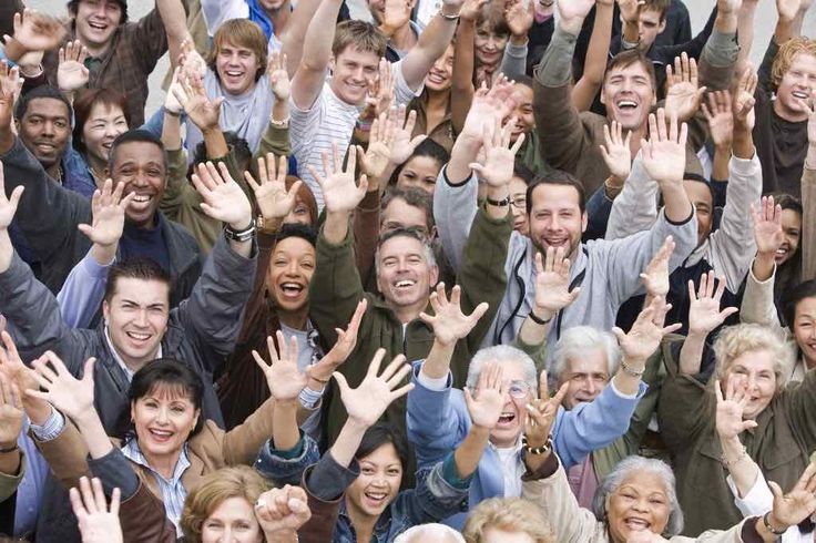 a group of people with their hands in the air