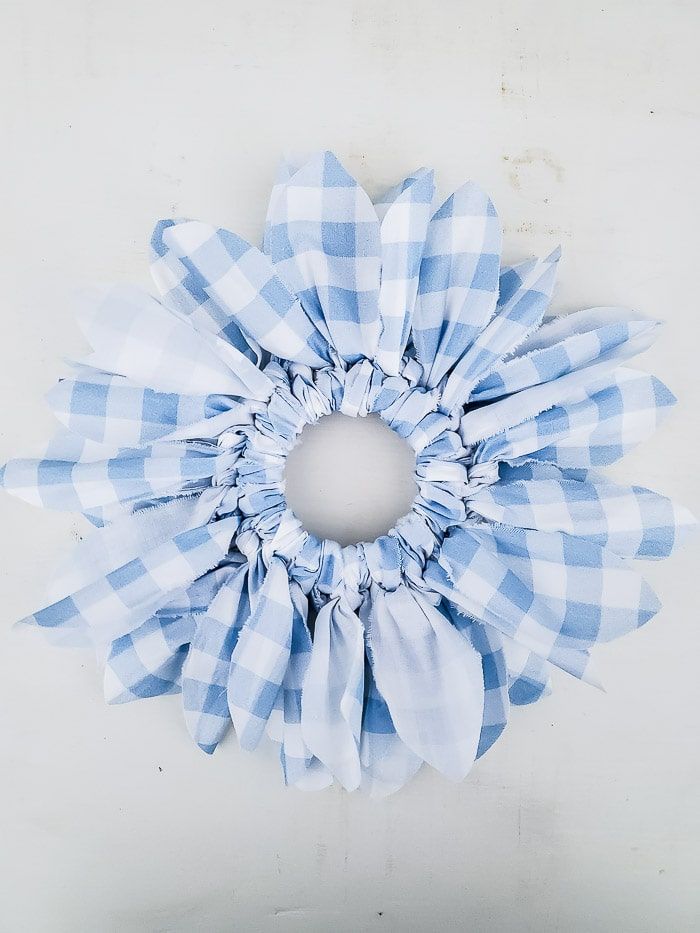 a blue and white checkered flower on the wall