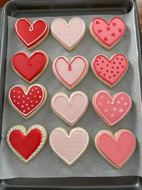 heart shaped cookies on a cookie sheet ready to be baked in the oven for valentine's day