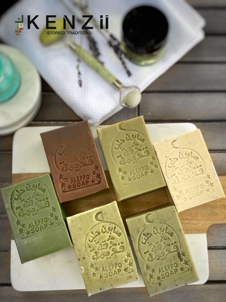 four bars of soap sitting on top of a wooden table